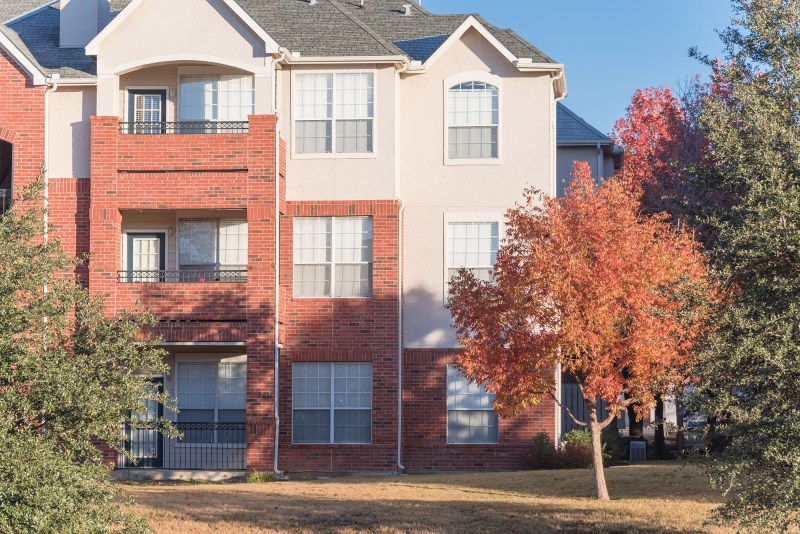 Typical apartment building complex near Dallas, Texas, USA in fall season with colorful autumn leaves.