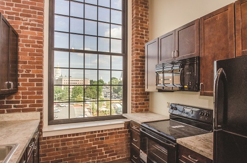 All units have modern appliances including refrigerators, dishwashers, central air conditioning, and walk-in closets.