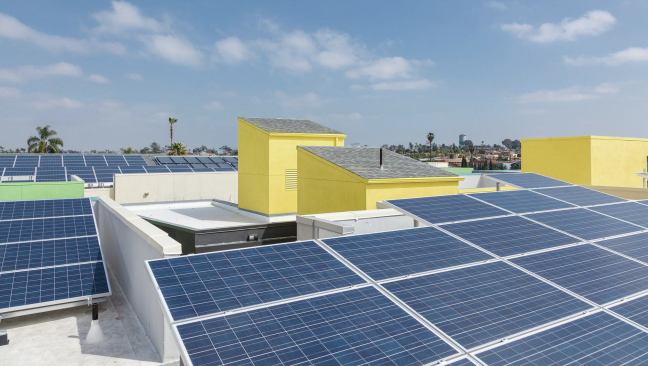 A 109 kV photovoltaic system provides virtually 100 percent of common area electricity, and a 50-collector domestic solar hot water system on the roof offsets 70 percent of tenant water and space heating costs.
