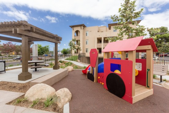 The development's design and furnishings are inspired by Vista's history. The Santa Fe Railroad began service in the late 1880s, and the Sprinter train now uses the same tracks. To honor that history, train accents can be found throughout the development, including the tot lot in the courtyard.