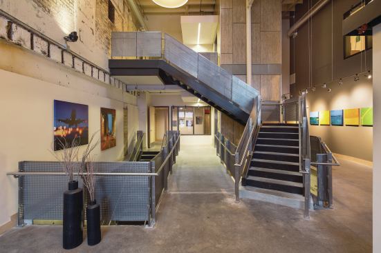 Designed with artists in mind, the project takes advantage of the building’s high ceilings and natural light to create a unique space for residents to work and display their art.
