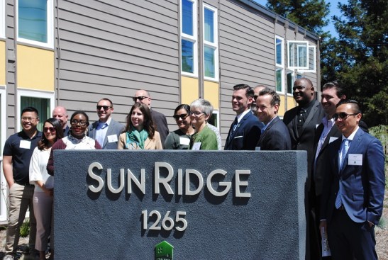 Officials at Community HousingWorks and their partners celebrate the completion of renovations at Sun Ridge Apartments.