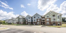 In addition to 100 affordable homes, Legacy Ridge includes a central outdoor recreation area with seating and a playground, a picnic shelter with an outdoor grill, and a clubhouse building, featuring a community room, a fitness center, a computer center, and leasing offices.